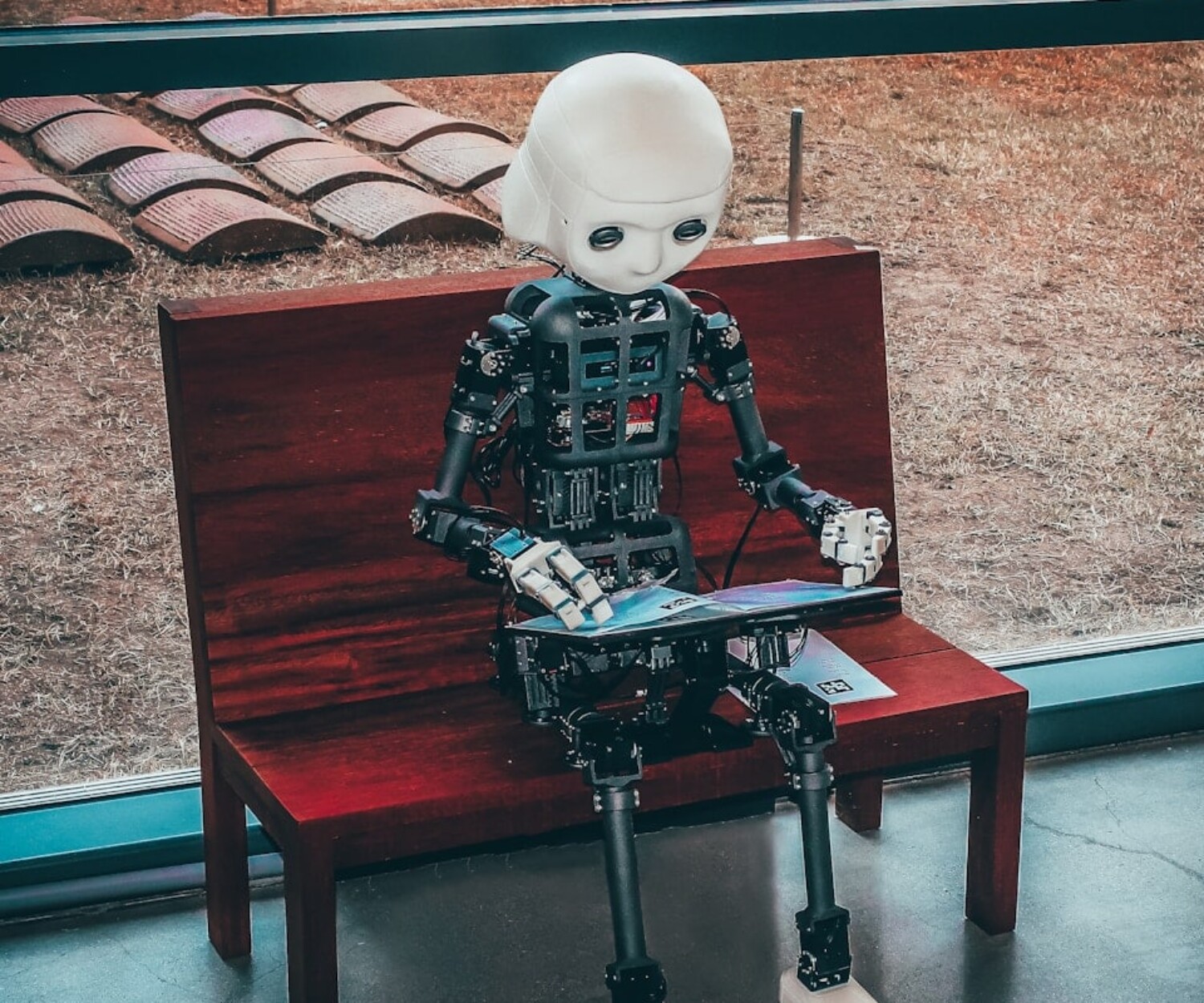 black and white robot toy on red wooden table